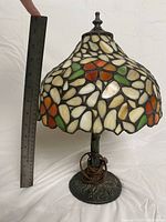 Full view of Tiffany style table lamp next to a ruler showing approximately 13 inches tall.