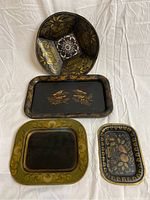 Top view of 3 trays and 1 divided round bowl with decorative painted details