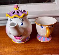 Photo of Mrs. Potts Scentsy Warmer and Chip Mug side by side, showing front and facial features.