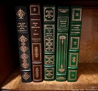 Group photo of five Franklin Library books on shelf showing spines with titles and decorative gold gilt embossing