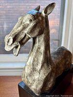 Close-up angled view of the horse bust sculpture showing facial details and textured surface.