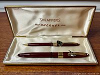 Closed view of Sheaffer Snorkel pen and pencil in original satin-lined display box.