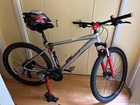 Side view of Marin Bobcat Trail 3 mountain bike with helmet mounted on seat, showing frame, wheels, and mounted travel pump