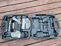 Porter Cable BN 200A Brad nailer in black plastic carrying case with a box of nails and an oil bottle.