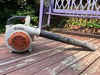 Side view of Stihl leaf blower showing overall shape, handle, and blower tube.