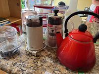 Overall kitchen counter shot of all items in lot: Le Creuset teapot, Bodum Chocolatier French press, Braun KSM2 grinder, Herbie Jr teapot base visible