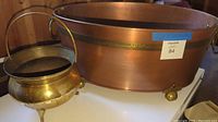 Front and side view showing large copper tub with brass bands and feet along with brass spittoon