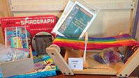 Full lot view showing Easy Weaver loom with rainbow yarn, Kenner Spirograph box, newer Spirograph set with instruction booklet, bags of beads, other boxed craft supplies