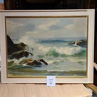 Framed ocean wave artwork depicting Pacific surf scene with waves crashing against rocky shore.