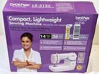 Original packaging box showing the Brother LX-3125 Compact Lightweight Sewing Machine with a smiling woman, branding, key features and basic machine image
