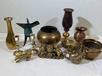 Full lot photo showing 10 brass and metal decorative items including vases, candlesticks, pots, and figurines.