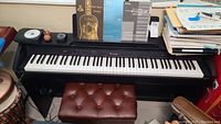 Front view of Casio Privia PX-850 digital piano on stand with bench and sheet music