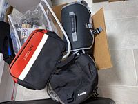 Photo of musical equipment cases and bags including Justin and Canon brands