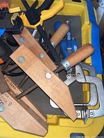 Photo of wood clamps with wooden handles and a metal vice partially visible