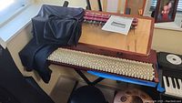 Whole Tone Revolution synthesizer and Array Mbira on stand with stool