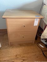 Front view of one nightstand showing two drawers and round metal handles