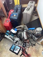 Overview of multiple power tool heads, cases and accessories on floor