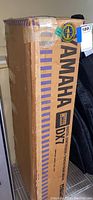 Yamaha DX7 cardboard shipping box upright on shelf