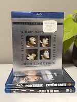 Stack of three Blu-ray movies including The Beatles' A Hard Day's Night on top, with Point Break and Play It To The Bone below.