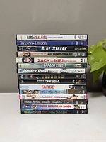 Stack of 15 DVD cases showing spines of titles.