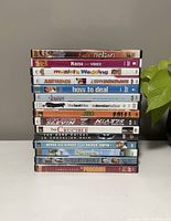 Stack of 15 DVD movies titles visible with various colors and fonts