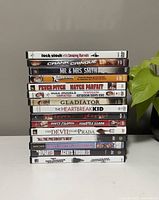 Stack of 15 DVD movie cases with visible titles including Lock, Stock and Two Smoking Barrels, Crank, Mr. & Mrs. Smith, and more