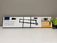 Box of Insignia TV Wall Mount showing entire packaging laid flat on counter.