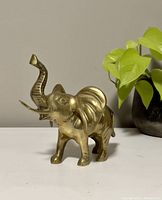 Front view of the brass elephant figurine showing the raised trunk and overall shape