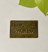 Top view of the brass non smoking sign showing embossed text 'THANKS FOR NOT SMOKING'