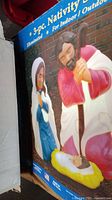 Box showing the 3-piece illuminated blow mold nativity set with images of Mary, Joseph, and baby Jesus, intended for indoor and outdoor use.