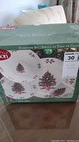Photo of Gibson Noel Morning 16-piece Christmas china set original box showing decorated Christmas tree designs with holly accents