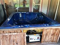 Front angle showing wood frame panel opened to reveal pump and control unit
