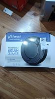 Boxed view of the Eternal Home Essentials rechargeable vacuum cleaner showing front design and price sticker.