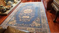 Full view of rug in living room setting showing overall pattern and condition