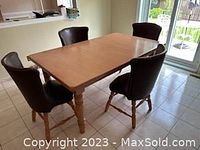 Four chairs arranged around a table showing overall set and style
