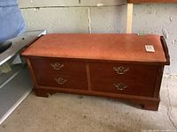 Full view of Lane cedar chest with reddish-brown finish and visible scratches.