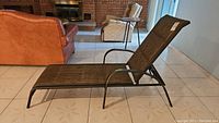 Full side angled view of the lounge chair showing fabric and metal frame construction.