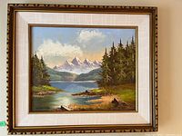 Full view of framed mountain lake landscape painting showing frame and canvas artwork.