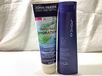 Photo of both shampoo bottles: John Frieda Deep Sea Hydration Moisturizing Shampoo 250ml and Joico Daily Care Balancing Shampoo 300ml side by side on a white surface.