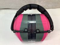 Front side view of pink and gray Champion ear puffs showing collapsible design and padded black headband