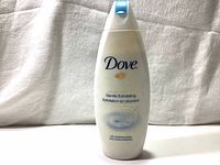 Front view of the Dove Gentle Exfoliating Beauty Body Wash bottle showing the Dove logo, product name, and packaging details.