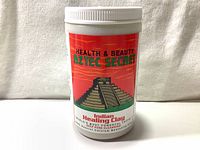 Front view of the sealed container of Aztec Secret Indian Healing Clay with primary branding and product name visible