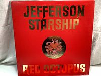 Front cover of Jefferson Starship Red Octopus album with red background, gold text, and octopus heart logo.