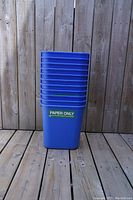 Stack of 11 blue plastic recycling bins for paper only, rectangular shape, sized to fit under desks.