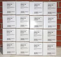 Stack of 16 boxes of HP CE411A (305A) cyan toner cartridges by NuPrint, showing front labels with part number and model details.
