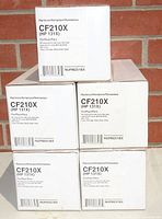 Stacked retail boxes showing CF210X (HP 131X) model number and branding indicating these are black high yield toner cartridges.