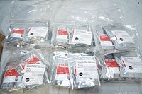 Eight sealed silver foil bags each labeled Staples Canon CL-241XL Inkjet Color, placed on white background.