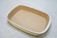 Top-down view showing smooth beige interior and wide rim edges.