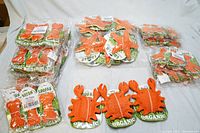 Multiple packaged Hip Doggie organic loofah dog chew toys in orange, including crab and starfish shapes stacked in a box.