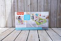 Box of new open box Fisher Price Infant-to-Toddler Baby Rocker Bouncy Chair showing front with baby images and product info